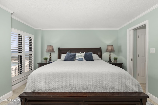 bedroom with crown molding, a textured ceiling, and baseboards