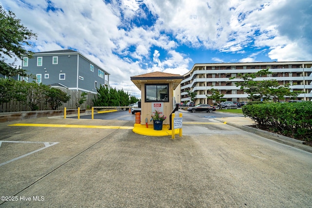 exterior space featuring uncovered parking and fence