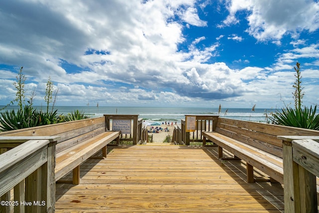 dock area featuring a deck with water view and a view of the beach