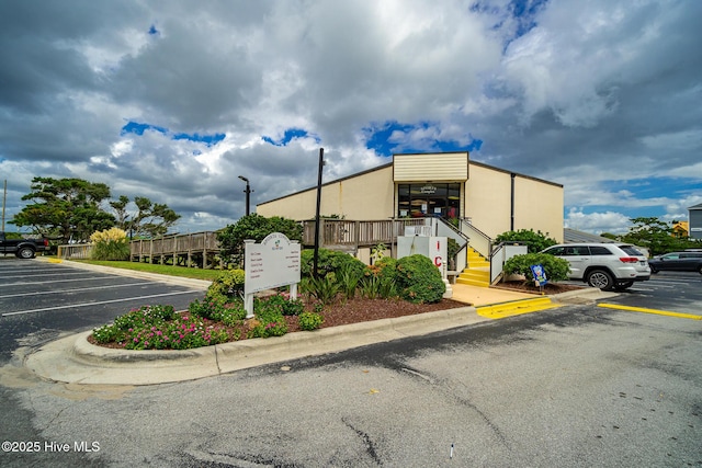 view of building exterior featuring uncovered parking