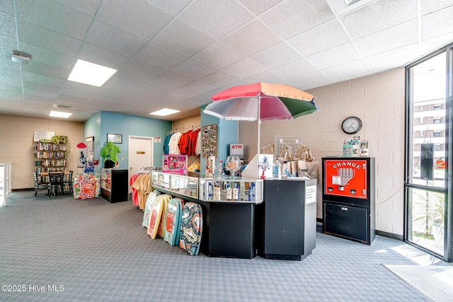 misc room featuring carpet flooring, a drop ceiling, and visible vents