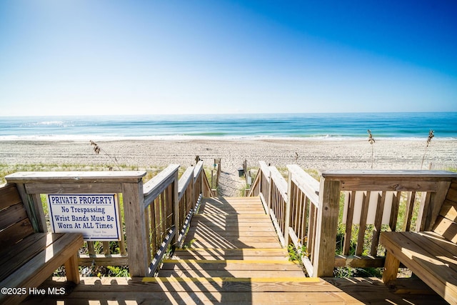 view of community with a view of the beach and a water view