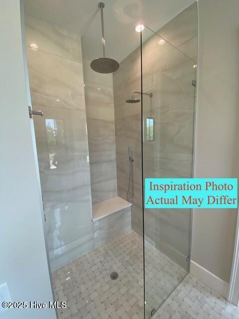 full bathroom featuring tiled shower