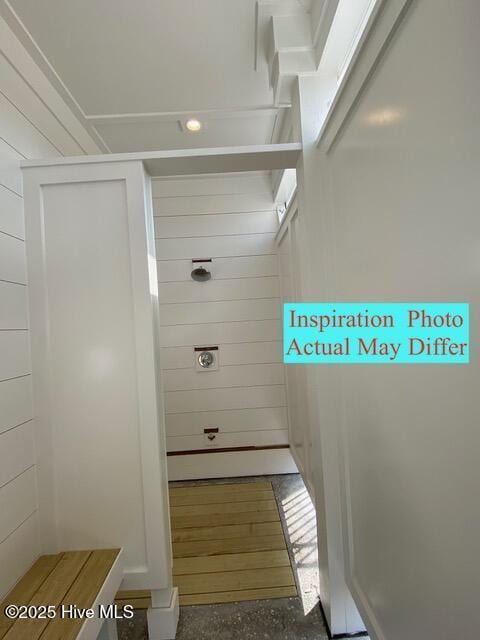 bathroom featuring wood walls