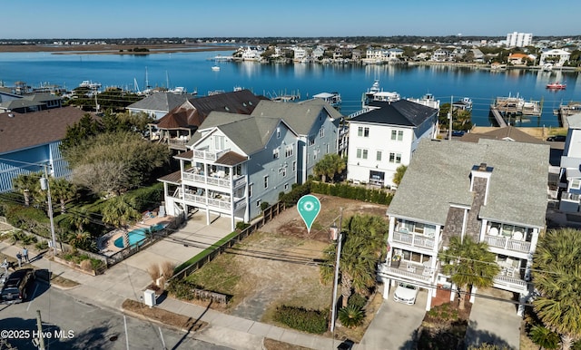 birds eye view of property with a water view and a residential view