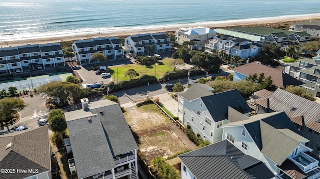 aerial view featuring a water view, a view of the beach, and a residential view