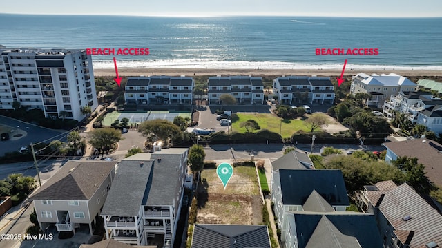 birds eye view of property with a beach view and a water view