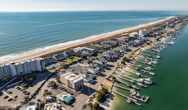 drone / aerial view featuring a beach view and a water view