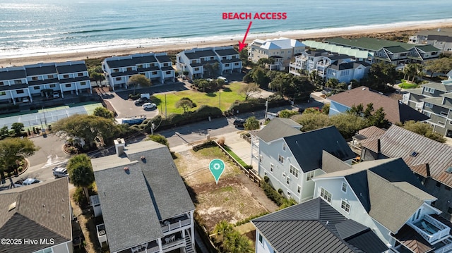 birds eye view of property featuring a water view, a view of the beach, and a residential view