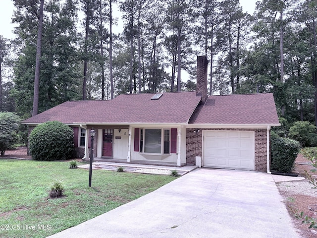 16 Bayberry Cir, Calabash, NC 28467 - ranch-style house with a garage, a porch, concrete driveway, a front lawn, and brick siding