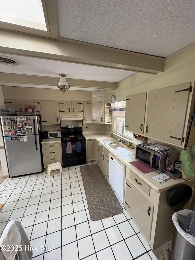 16 Bayberry Cir, Calabash, NC 28467 - kitchen with stainless steel appliances, light countertops, a textured ceiling, light tile patterned floors, and open shelves