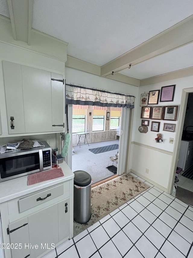 16 Bayberry Cir, Calabash, NC 28467 - kitchen with stainless steel microwave, light countertops, beam ceiling, and light colored carpet