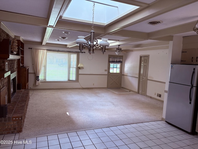 16 Bayberry Cir, Calabash, NC 28467 - kitchen featuring freestanding refrigerator, light carpet, a chandelier, coffered ceiling, and a brick fireplace