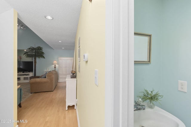 104 Island Quay Ct, Atlantic Beach, NC 28512 - hall featuring light wood-type flooring, recessed lighting, a textured ceiling, and a sink