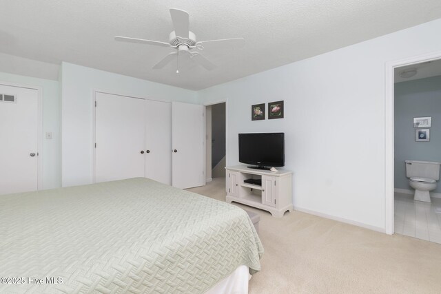104 Island Quay Ct, Atlantic Beach, NC 28512 - bedroom featuring light carpet, a closet, connected bathroom, ceiling fan, and baseboards