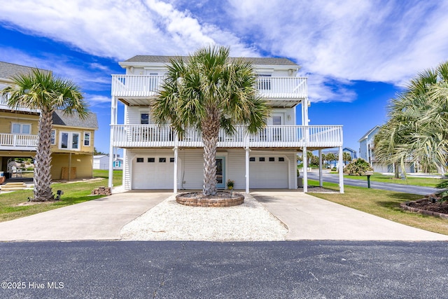 104 Island Quay Ct, Atlantic Beach, NC 28512 - coastal home featuring an attached garage, concrete driveway, and a balcony
