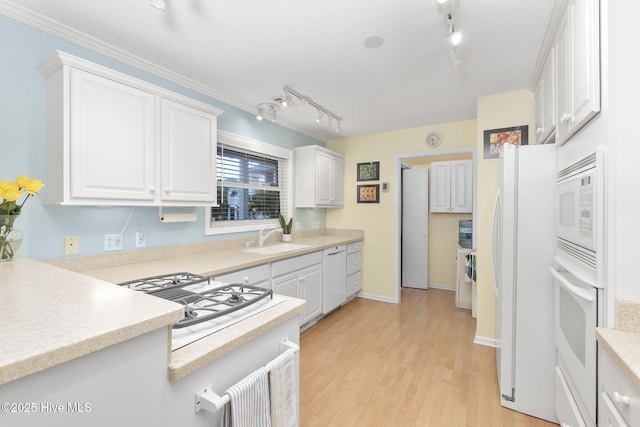 104 Island Quay Ct, Atlantic Beach, NC 28512 - kitchen featuring a sink, white appliances, track lighting, white cabinetry, and light countertops