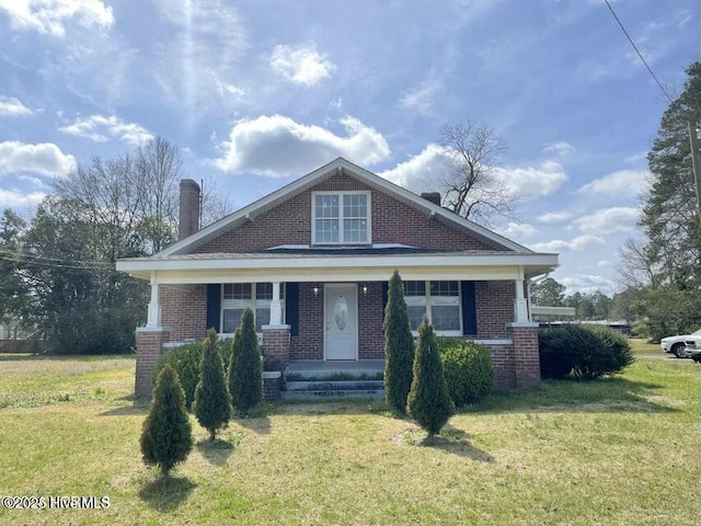 view of front of property with brick siding and a front yard