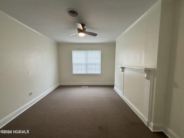 unfurnished room featuring baseboards, ornamental molding, a ceiling fan, and dark carpet