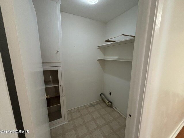 laundry area with tile patterned floors, hookup for an electric dryer, and laundry area