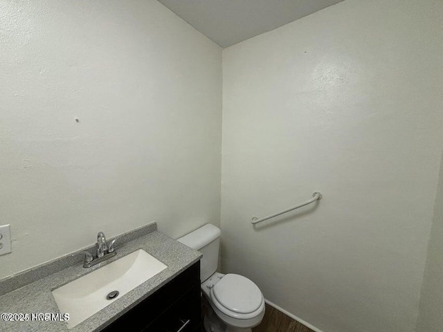 bathroom with toilet and vanity