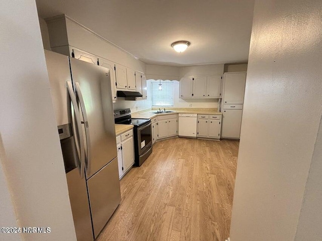 kitchen with light wood finished floors, a sink, stainless steel appliances, under cabinet range hood, and light countertops