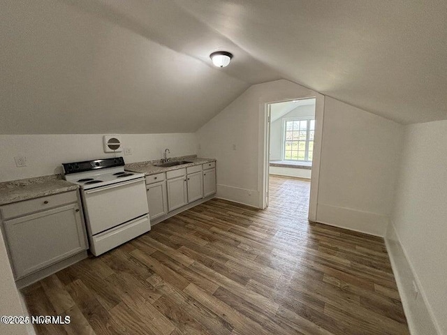 interior space featuring light countertops, vaulted ceiling, white range with electric stovetop, a sink, and dark wood-type flooring
