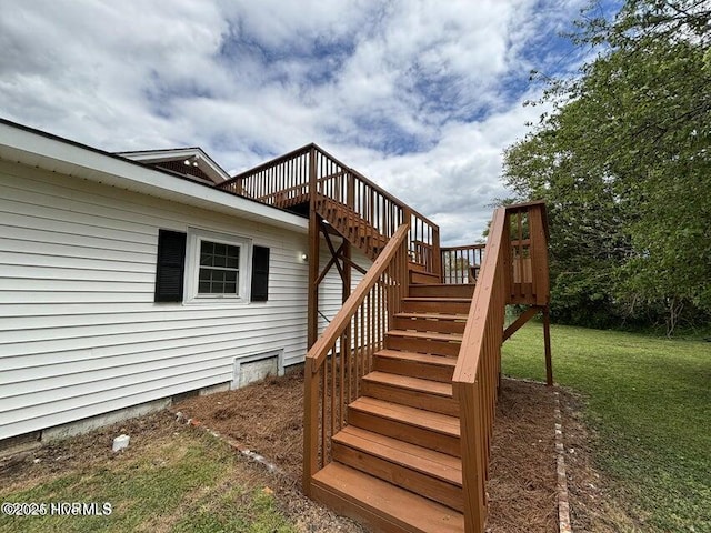 exterior space with crawl space, a wooden deck, and a yard