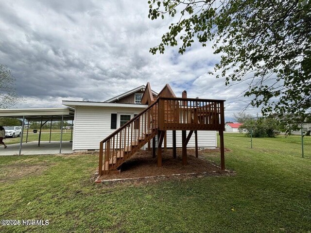 back of house with crawl space, a lawn, stairs, a carport, and a deck