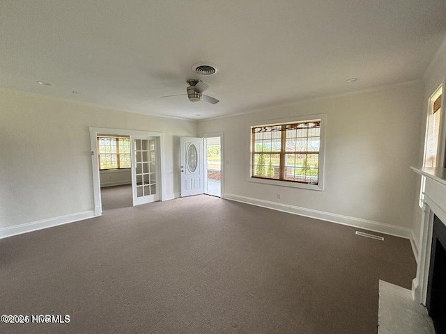 unfurnished living room with a ceiling fan, visible vents, a fireplace with flush hearth, and baseboards