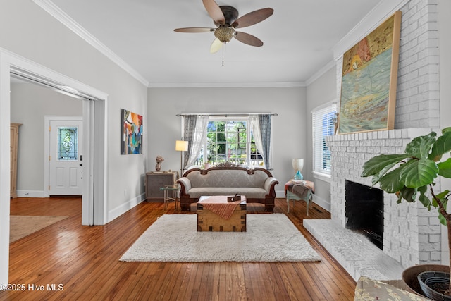 living area featuring wood-type flooring, ceiling fan, and a healthy amount of sunlight