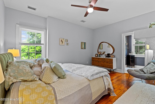 bedroom featuring a ceiling fan, hardwood / wood-style flooring, and visible vents