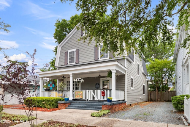 view of front of house featuring a porch, ceiling fan, and fence