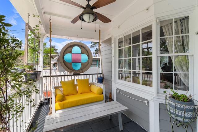 exterior space with ceiling fan and a porch