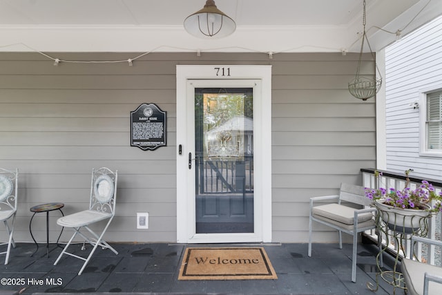 doorway to property with covered porch