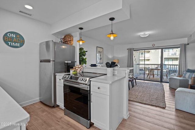 kitchen featuring light countertops, white cabinetry, open floor plan, light wood-style floors, and stainless steel appliances