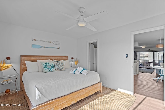 bedroom featuring wood finished floors and baseboards