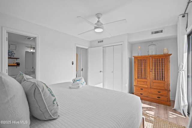 bedroom with a closet, visible vents, and light wood-style flooring