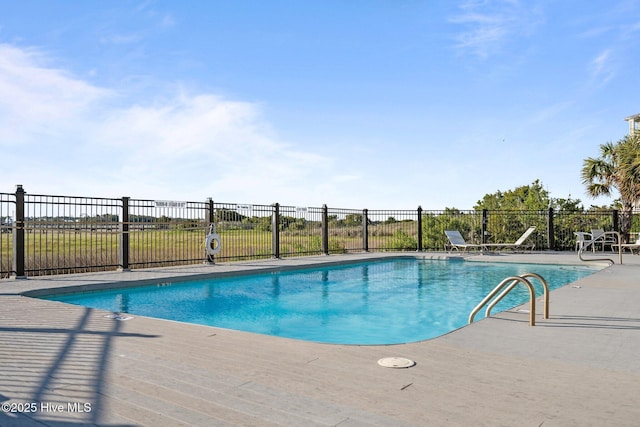 pool with fence and a patio