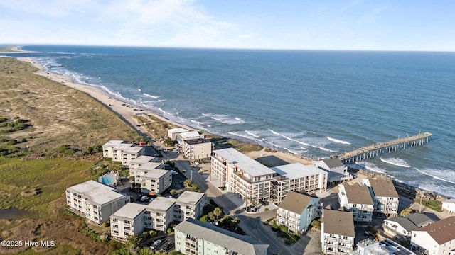 birds eye view of property featuring a water view and a beach view