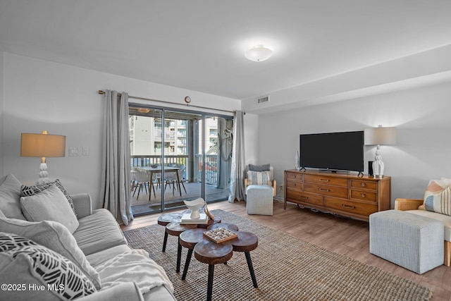 living room with visible vents and wood finished floors