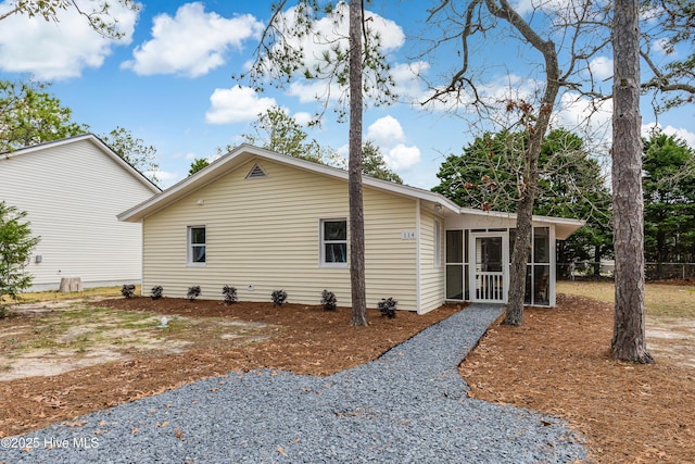 view of side of home with a sunroom