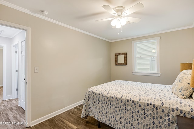 bedroom featuring a ceiling fan, baseboards, crown molding, and wood finished floors