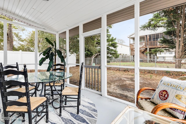 sunroom featuring outdoor dining space