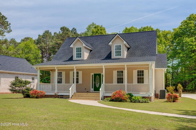 1708 N County Dr, Castle Hayne, NC 28429 - view of front of house featuring central AC, covered porch, a front yard, and roof with shingles