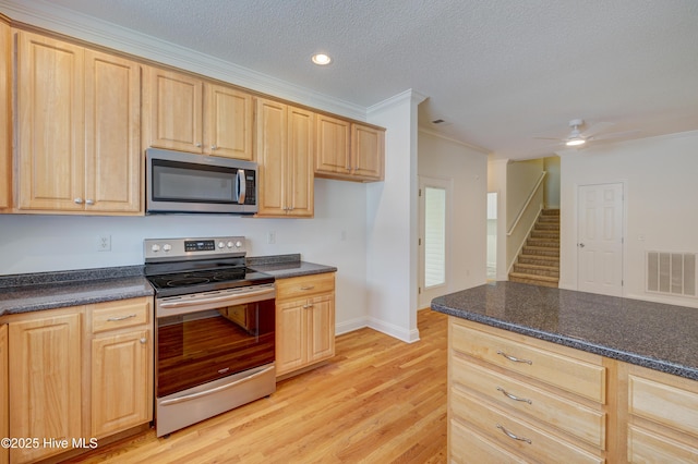 1708 N County Dr, Castle Hayne, NC 28429 - kitchen with stainless steel appliances, light wood-style flooring, light brown cabinets, ornamental molding, and ceiling fan