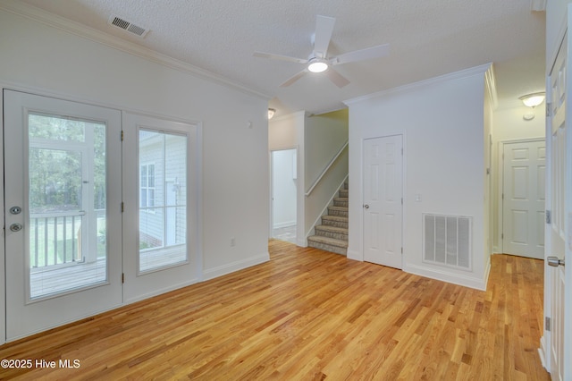 1708 N County Dr, Castle Hayne, NC 28429 - empty room with ornamental molding, light wood-style flooring, stairs, a ceiling fan, and a textured ceiling