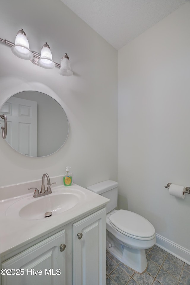 1708 N County Dr, Castle Hayne, NC 28429 - half bathroom with vanity, toilet, tile patterned flooring, and baseboards