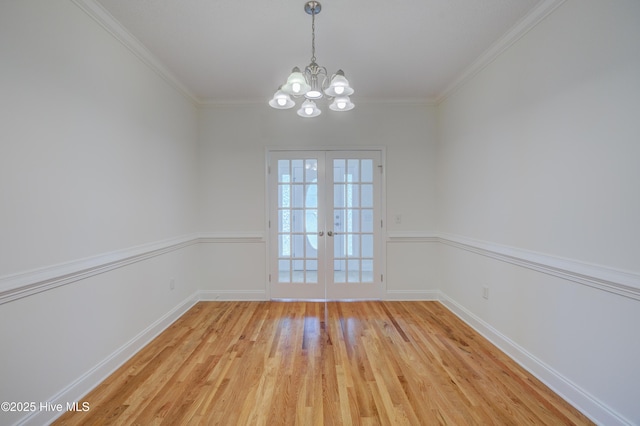 1708 N County Dr, Castle Hayne, NC 28429 - unfurnished dining area with a chandelier, light wood-style flooring, french doors, crown molding, and baseboards