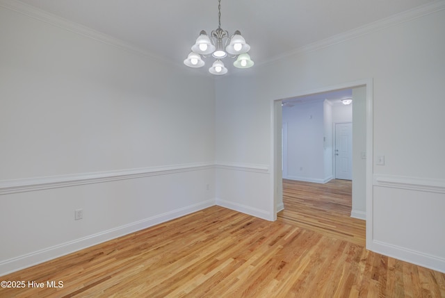 1708 N County Dr, Castle Hayne, NC 28429 - empty room with a chandelier, light wood finished floors, crown molding, and baseboards